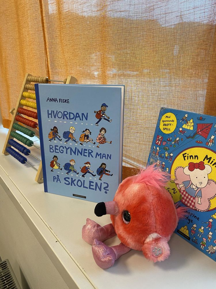 en bok og et kosedyr på en seng