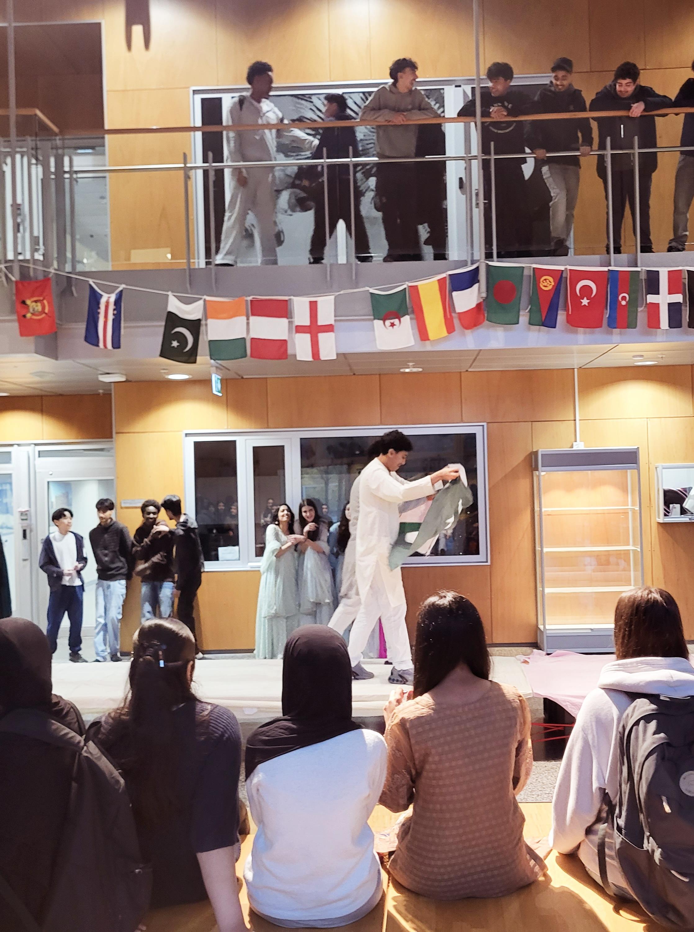 en gruppe mennesker som står i et rom med en person i en hvit kappe og en hvit kappe